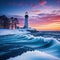 lighthouse on snowy shore with sunset in