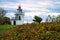 Lighthouse, Spodsbjerg Fyr in Huntsted on the coast of Denmark. Sun rays shining