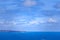 Lighthouse standing on rugged cliff edge overlooking the blue ocean in Australia.