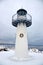 Lighthouse with a star at the entrance to the inner Harbor of the yacht port