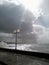 Lighthouse in the storm. Sea storm Stormy clouds Beam of sunlight between clouds