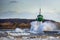 Lighthouse during storm in splashing spray in Travemuende, tourist destination on the Baltic Sea in the Luebeck bay, copy space