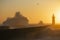 Lighthouse with stormy Atlantic wave during a beautiful sunset, Porto, Portugal.