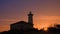 The lighthouse at sunset on the beach at the mouth of the river Tagliamento, Bibione, Venezia, Italy.