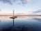 Lighthouse at sunset. An incredible landscape. Calm water surface and beautiful sky