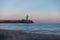 Lighthouse at sunset overlooking the calm sea