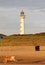 Lighthouse at sunset in the twilight. Egmond aan Zee, North Sea, the Netherlands.