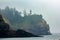 lighthouse tall and high over cliffs and pacific ocean