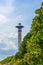 Lighthouse tower and blue summer sky, the safe return of the ship, maritime safety