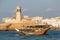 Lighthouse and traditional boat in Sur, Oman