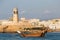 Lighthouse and traditional boat in Sur, Oman