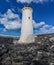 Lighthouse wide angle blue sky with clouds