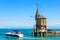 Lighthouse and yacht in harbor of Constance or Konstanz, Germany. Beautiful scenic view of Constance Lake Bodensee in summer