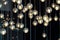 Lighting balls on the chandelier in the lamplight, light bulbs hanging from the ceiling, lamps on the dark background, selective