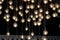 Lighting balls on the chandelier in the lamplight, light bulbs hanging from the ceiling, lamps on the dark background, selective