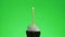 Lighting a blue candle on a delicious cupcake, green screen