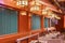 Lighting golden brass lanterns above a chozuya water ablution pavilion in Kanda Myojin Shrine.