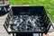 Lighting the home grill with coal, standing on a home garden on the paving stone.