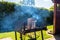 Lighting the home grill with coal, standing on a home garden on the paving stone.