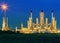 Lighting of oil refinery palnt against dusky blue sky of oil re