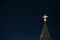 Lighting orthodox cross on a blue sky