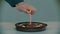 Lighting a pink candle on a cake with a lighter