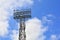 Lighting support. Stadium Post Lighting. Tall pillar with spotlights to illuminate a football stadium against the sky with clouds