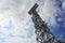 Lighting support. Stadium Post Lighting. Tall pillar with spotlights to illuminate a football stadium against the sky with clouds