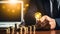 Lighting Up Ideas: Hand with Light Bulb Among Coins on Desk