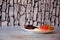 Lightly burnt beef steak with vegetables on a glass plate stands on a wooden table