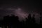 Lightning bolt at a dark night. Natural light in the night sky. Stormy weather