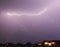 A Lightning Bolt Streaks Above a Neighborhood