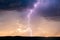 Lightning bolt strike in a storm at sunset