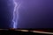 Lightning bolt strikes an electrical substation during a thunderstorm.