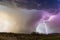 Lightning bolt strikes next to a microburst in a thunderstorm.