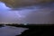 Lightning bolts in the sky over a lake in the vicinity of Rotterdam, The Netherlands