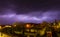 Lightning cracking during thunderstorm over houses of tiny town