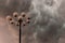 Lightning flashes stormy clouds over big, glorious street lamp