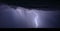 Lightning illuminates a thunderstorm in the night sky