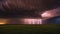 lightning over the field dramatic scene of a supercell thunderstorm and lightning bolt over a field in Kansas at sunset,
