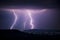 Lightning over the lights of a village in the night