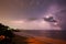 Lightning show above horizon at seashore