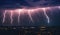 Lightning storm with huge electrical discharges on night sky, thunderstorm background