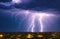 Lightning storm with huge electrical discharges on night sky, thunderstorm background