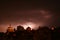 Lightning in a storm in old medival city with castle and a chapel (Kamnik, Slovenia)