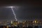 Lightning storm over the city at the summer heavy rain. Dramatic, breathtaking atmospheric natural phenomenon. Kyiv, Ukraine