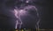 Lightning storm over countryside city at night in Thailand