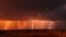 Lightning storm at sunset. Lightning strikes at dusk during the monsoon season. Spectacle of nature: lightning lights up the sky