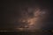 Lightning strikes through the cloud into the chimney of the factory, Singapore 2020