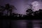 Lightning strikes during dramatic thunderstorm with silhouettes of trees and rain forest, Cameroon, Africa